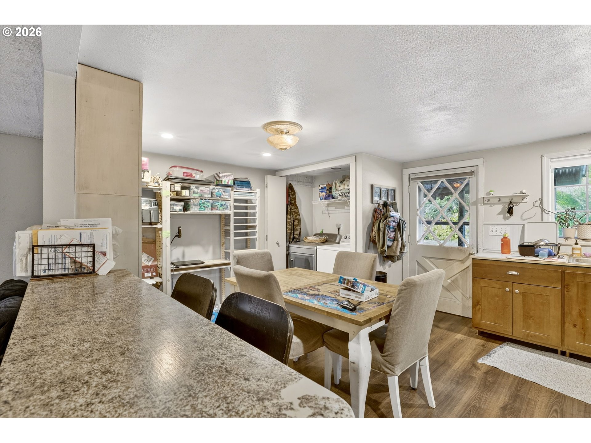 26200 Highway 211 Estacada, OR 97023 - Photo 7 of 24 a living room with furniture a large window and kitchen view