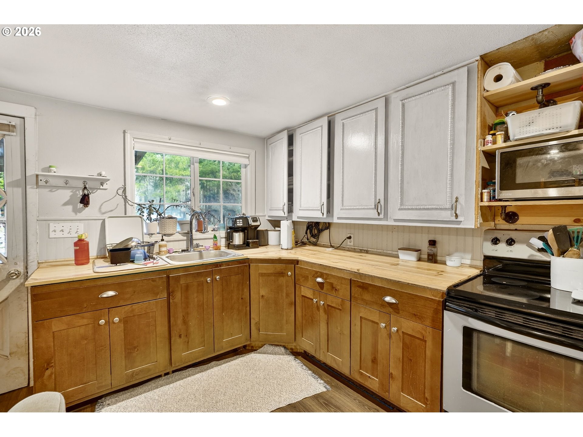 26200 Highway 211 Estacada, OR 97023 - Photo 9 of 24 a kitchen with a sink stove and cabinets
