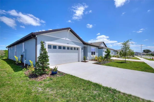 a front view of house with yard and green space