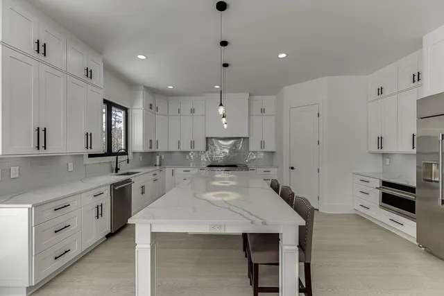 a bathroom with a shower sink vanity mirror and toilet