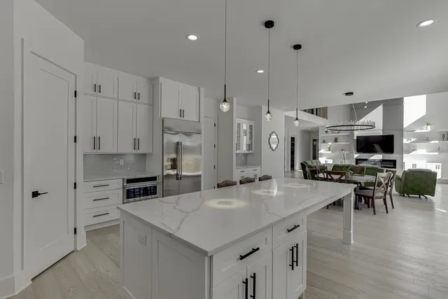 a kitchen with stainless steel appliances granite countertop a stove and a refrigerator