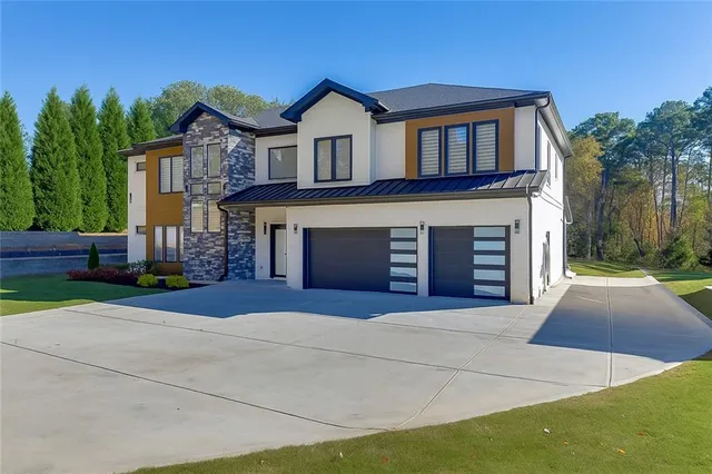 a front view of a house with a yard and garage