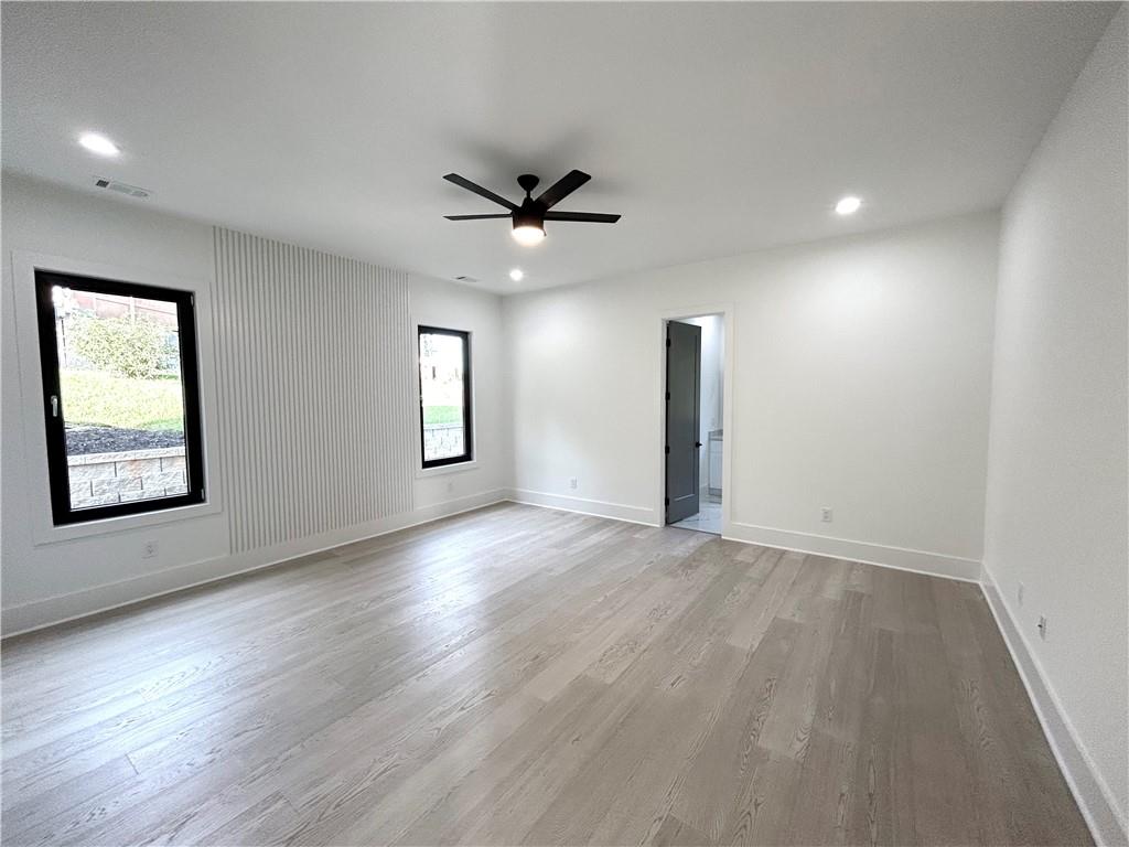 751 Rock Springs Road, Unit 2 Lawrenceville, GA 30043 - Photo 27 of 76 a view of an empty room with a window and wooden floor