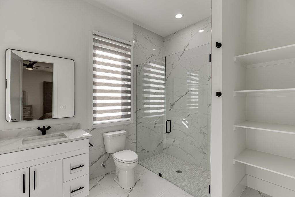 751 Rock Springs Road, Unit 2 Lawrenceville, GA 30043 - Photo 31 of 76 a bathroom with a shower sink vanity mirror and toilet