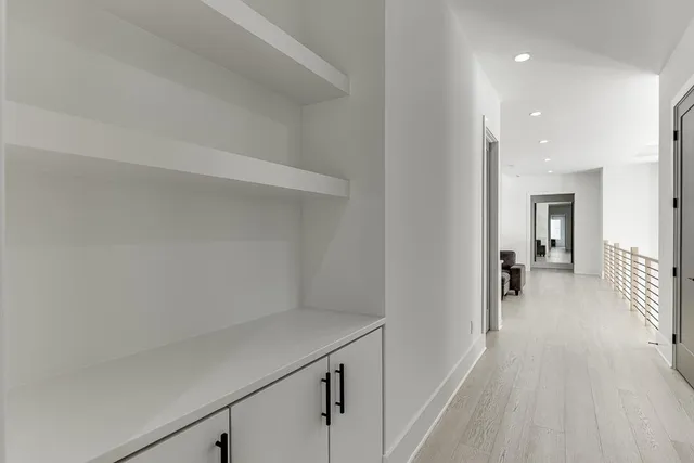 an empty room with windows ceiling fan and windows