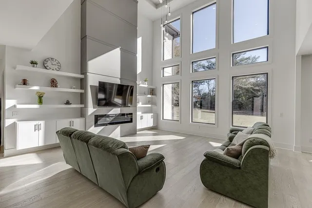 a living room with furniture fireplace and a flat screen tv