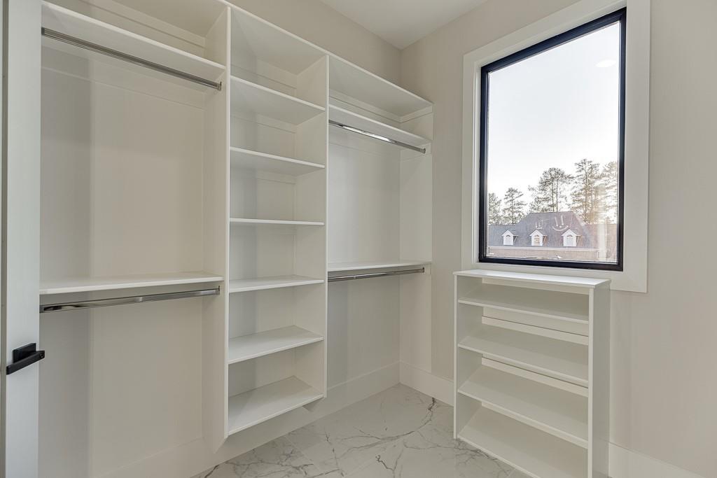 751 Rock Springs Road, Unit 2 Lawrenceville, GA 30043 - Photo 54 of 76 a view of walk in closet with empty racks