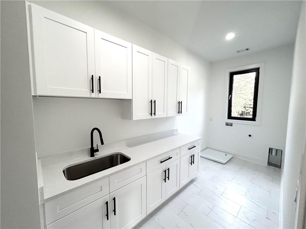 751 Rock Springs Road, Unit 2 Lawrenceville, GA 30043 - Photo 56 of 76 a kitchen with white cabinets and sink