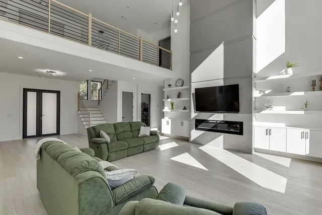 a living room with furniture tv and large window