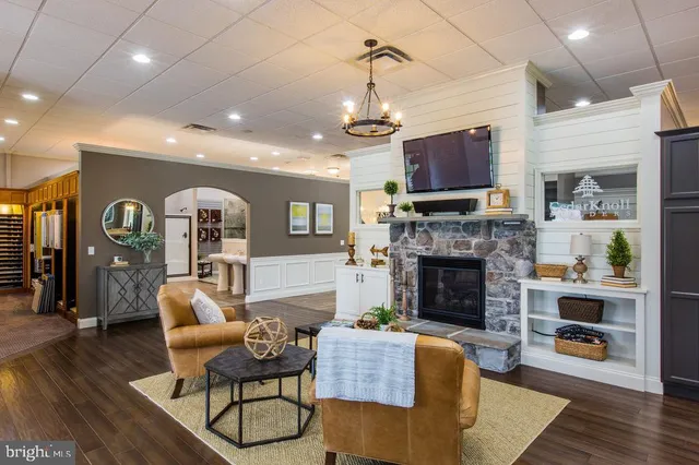 a kitchen with stainless steel appliances kitchen island granite countertop a refrigerator a stove oven and white cabinets