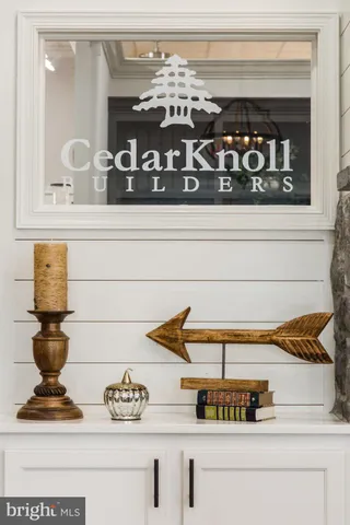 a view of kitchen and wooden cabinets