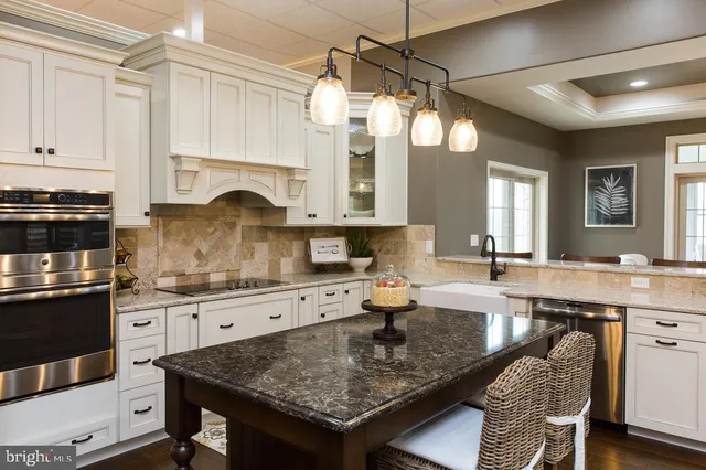 a kitchen with granite countertop a refrigerator and a stove