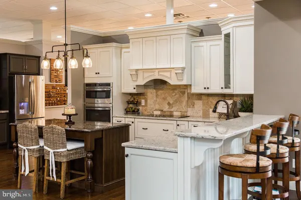 a sink with a granite countertop sink and a mirror