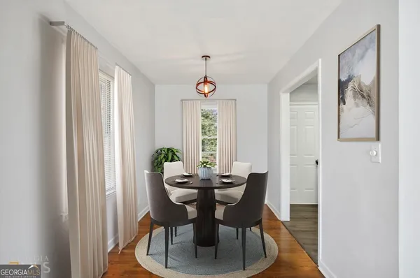 a dining room with furniture a chandelier and window
