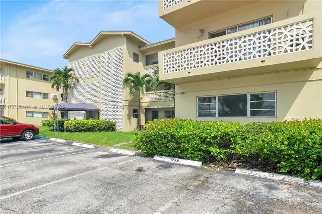 a front view of a building with garden