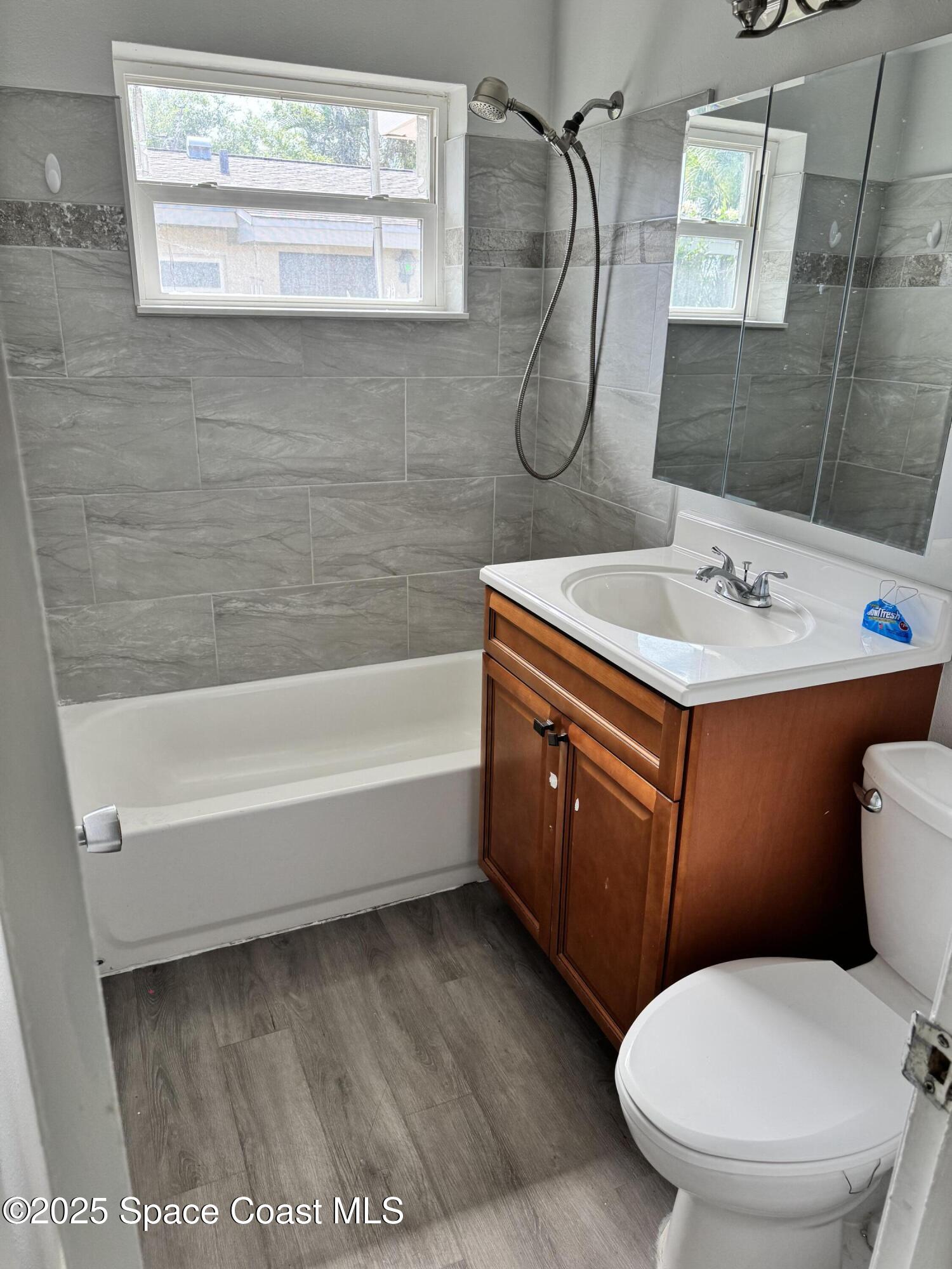 116 E Avenue Melbourne, FL 32901 - Photo 7 of 9 a bathroom with a toilet sink and mirror