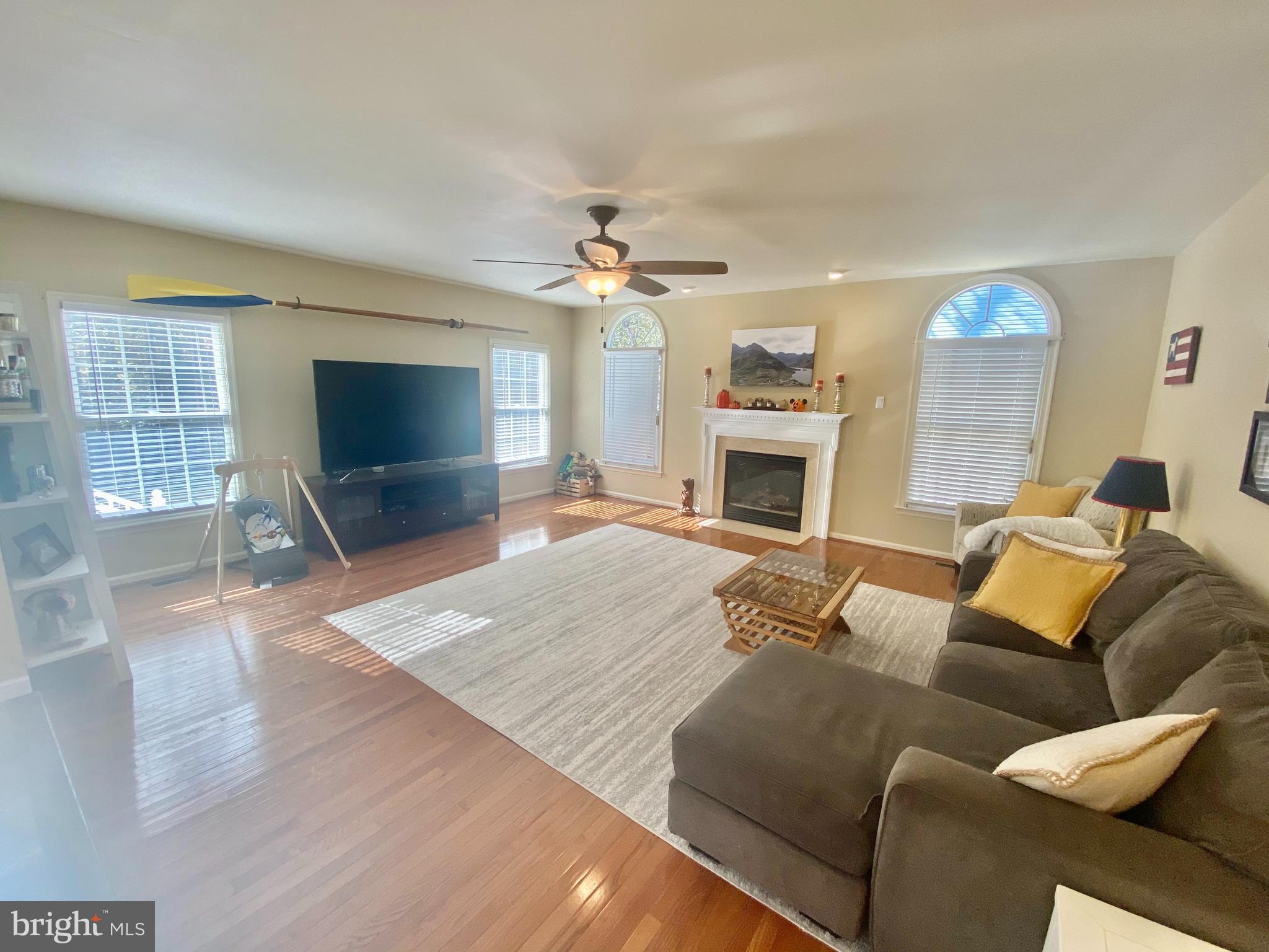 64 Tavern Road Stafford, VA 22554 - Photo 19 of 24 a living room with furniture a fireplace and a flat screen tv