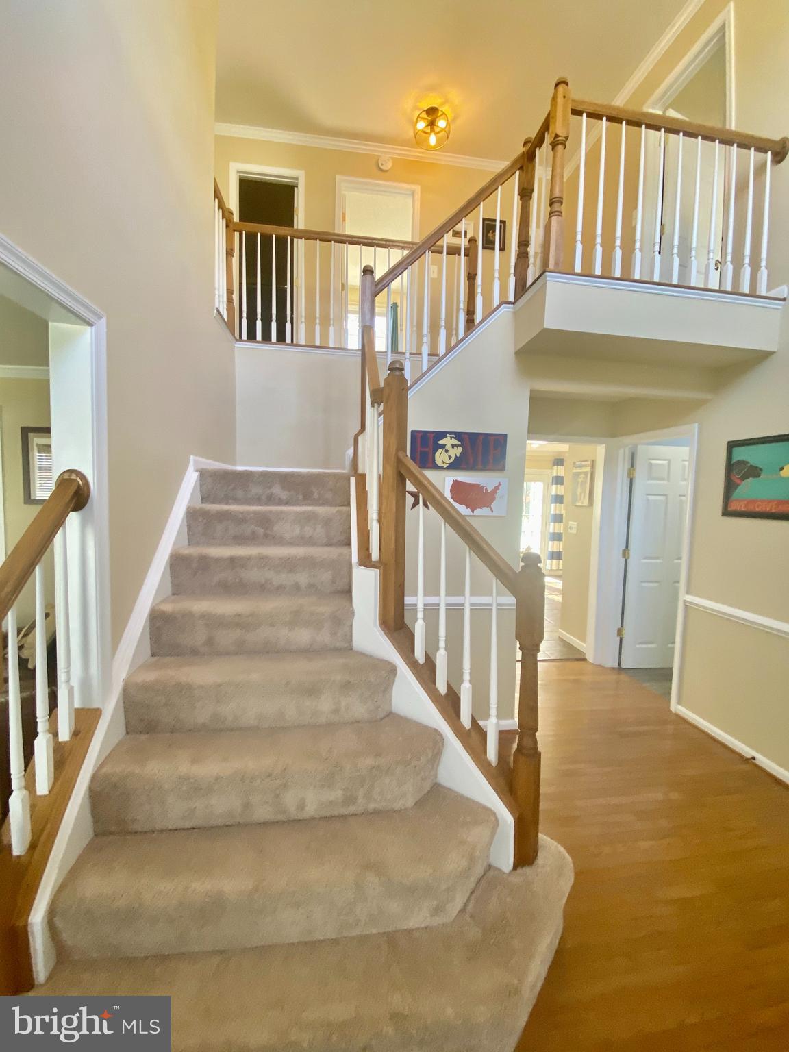 64 Tavern Road Stafford, VA 22554 - Photo 4 of 24 a view of staircase with lots of frames on wall and a view of a house