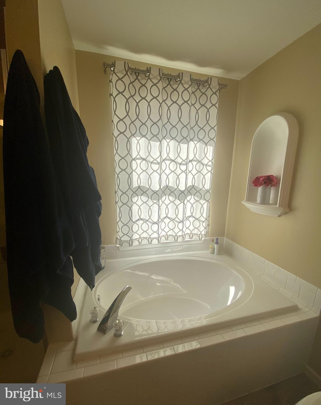 64 Tavern Road Stafford, VA 22554 - Photo 9 of 24 a bath tub sitting in a bathroom next to a window
