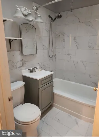 a bathroom with a toilet sink and shower
