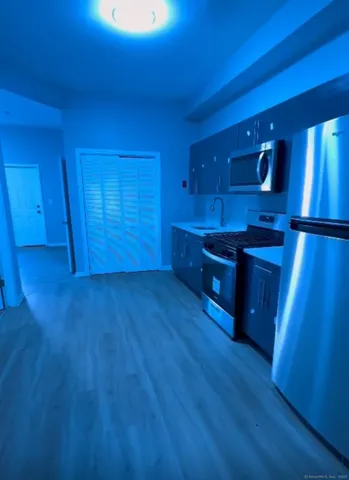 a kitchen with wooden floors and wooden cabinets