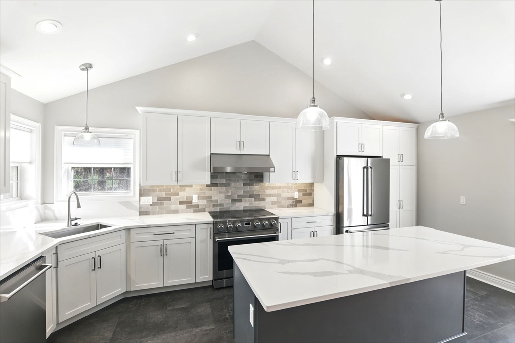 5 Bennett Road Hampden, MA 01036 - Photo 12 of 42 a kitchen with a white center island a sink cabinets and stainless steel appliances