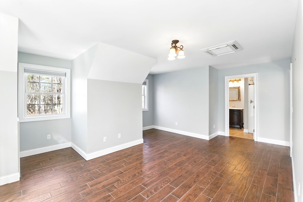 5 Bennett Road Hampden, MA 01036 - Photo 37 of 42 an empty room with wooden floor and natural light