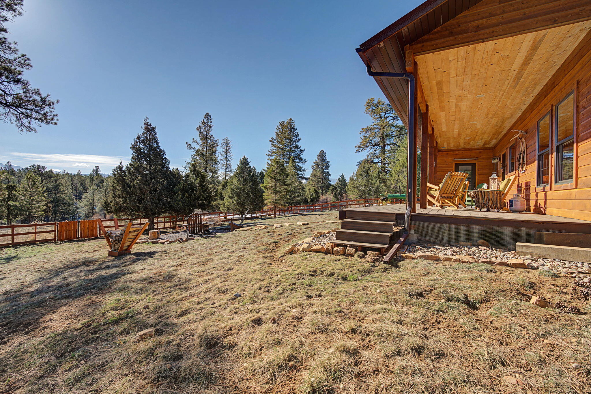 213 Big Canyon Point Ridgway, CO 81432 - Photo 22 of 41 a backyard of a house with wooden fence and trees