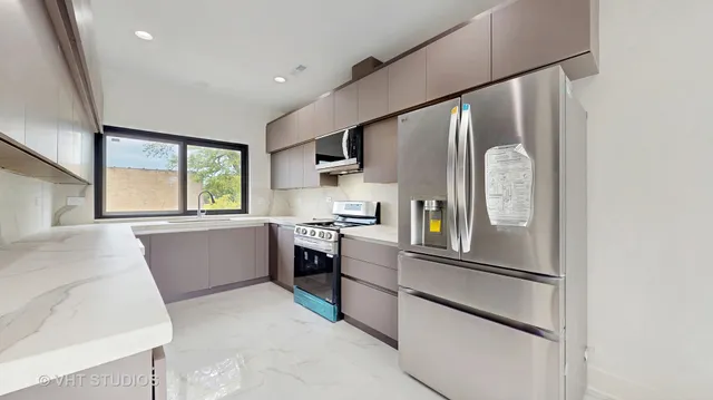 a kitchen with a refrigerator and windows