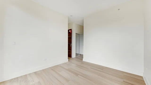 a view of a room with wooden floor and doors