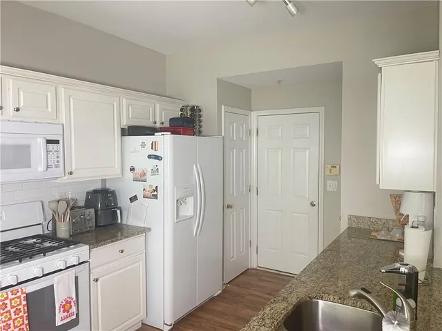 a kitchen with stainless steel appliances a refrigerator sink and cabinets