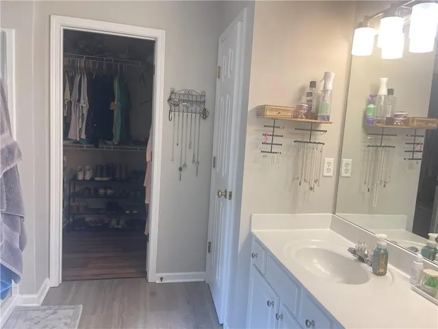 a bathroom with a granite countertop sink shower and a mirror