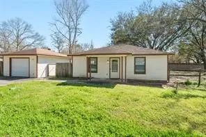 a house that has a lot of plants and trees in the background