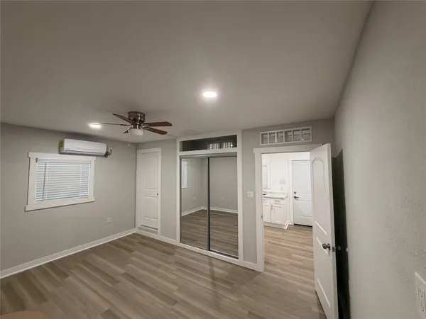 an empty room with wooden floor and a window
