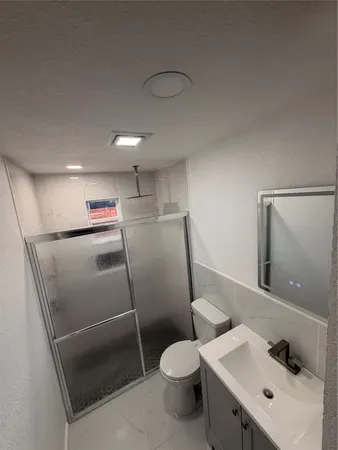 a bathroom with a toilet sink and shower