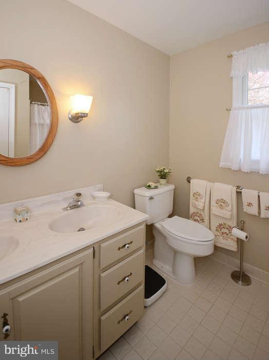 4453 Carroll Manor Road Baldwin, MD 21013 - Photo 18 of 30 a bathroom with a double vanity sink and a mirror