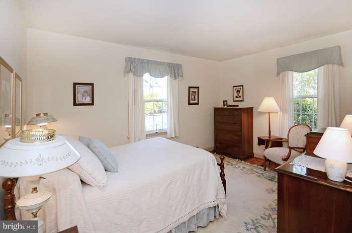 4453 Carroll Manor Road Baldwin, MD 21013 - Photo 19 of 30 a bedroom with a bed and dresser with mirror