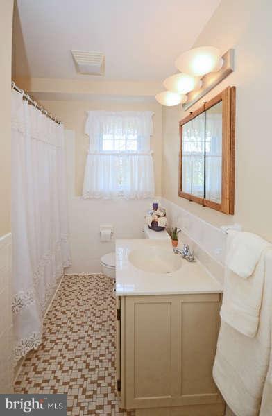 4453 Carroll Manor Road Baldwin, MD 21013 - Photo 21 of 30 a bathroom with a sink a vanity and a mirror