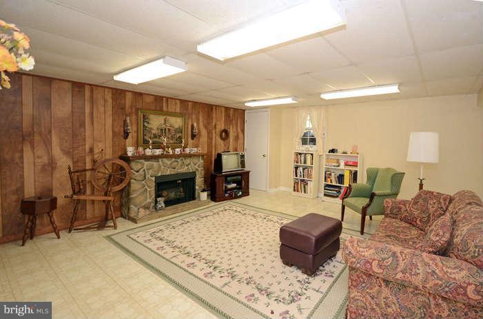 4453 Carroll Manor Road Baldwin, MD 21013 - Photo 24 of 30 a living room with furniture and a fireplace