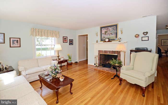 4453 Carroll Manor Road Baldwin, MD 21013 - Photo 4 of 30 a living room with furniture a fireplace and a window