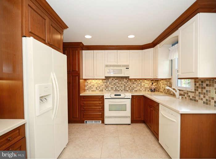 4453 Carroll Manor Road Baldwin, MD 21013 - Photo 7 of 30 a kitchen with stainless steel appliances granite countertop a refrigerator sink and stove