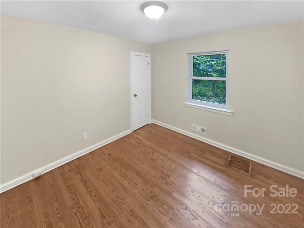3209 Credenza Road Charlotte, NC 28208 - Photo 14 of 20 an empty room with wooden floor and windows