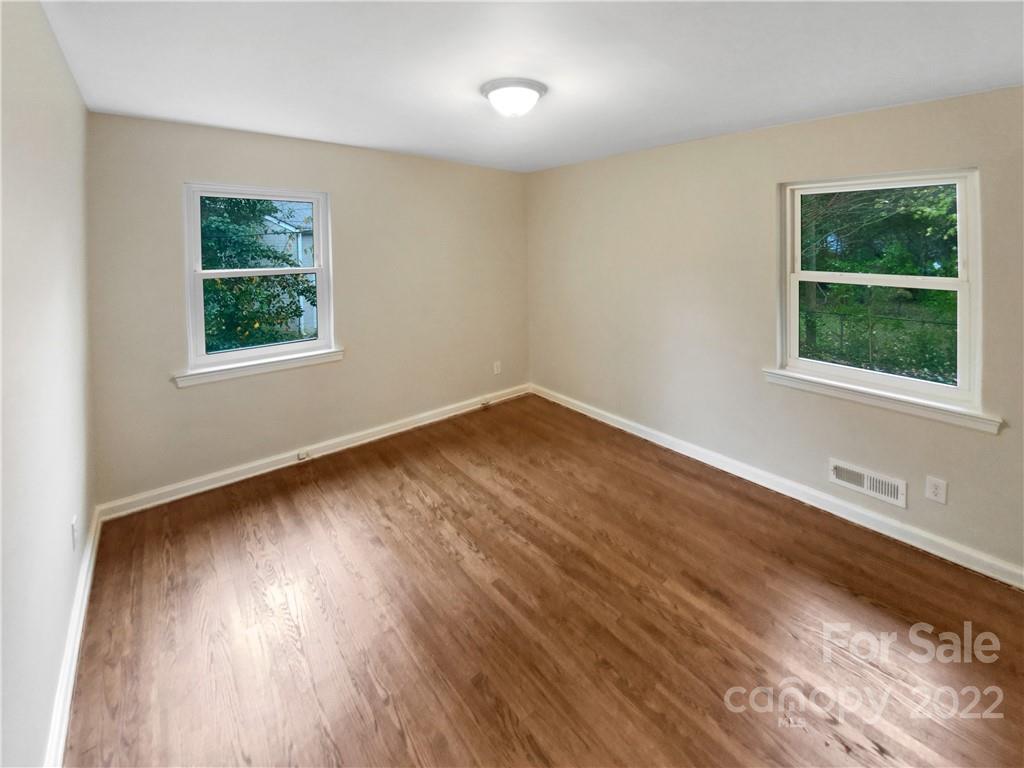3209 Credenza Road Charlotte, NC 28208 - Photo 15 of 20 a view of an empty room with wooden floor and a window