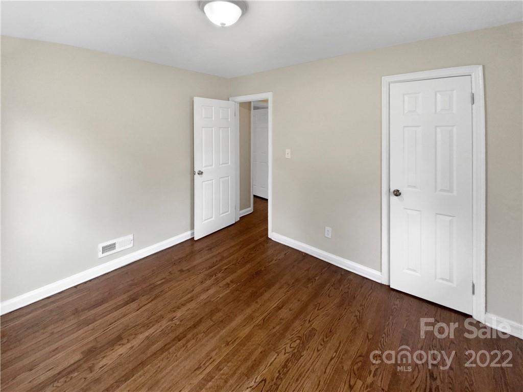 3209 Credenza Road Charlotte, NC 28208 - Photo 17 of 20 a view of an empty room with wooden floor