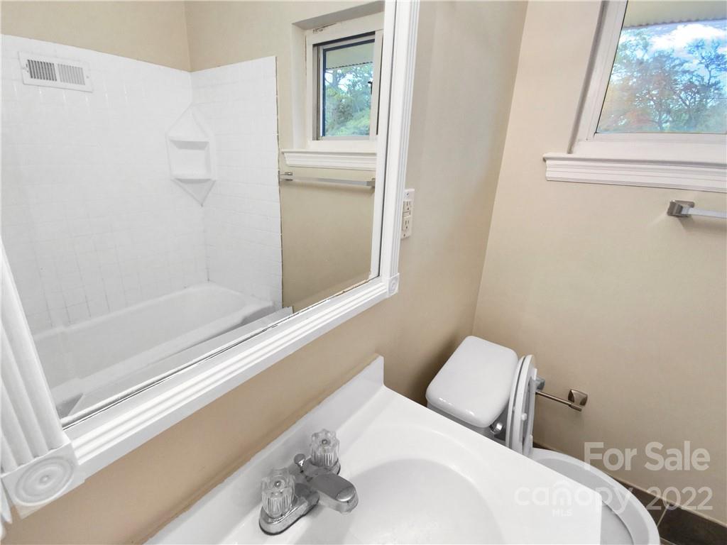 3209 Credenza Road Charlotte, NC 28208 - Photo 7 of 20 a bathroom with a sink and a mirror