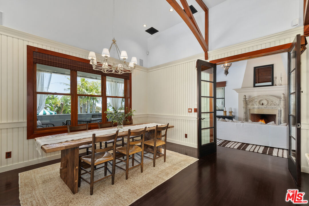 26799 Sea Vista Drive Malibu, CA 90265 - Photo 11 of 32 a view of a dining room with furniture a chandelier and wooden floor