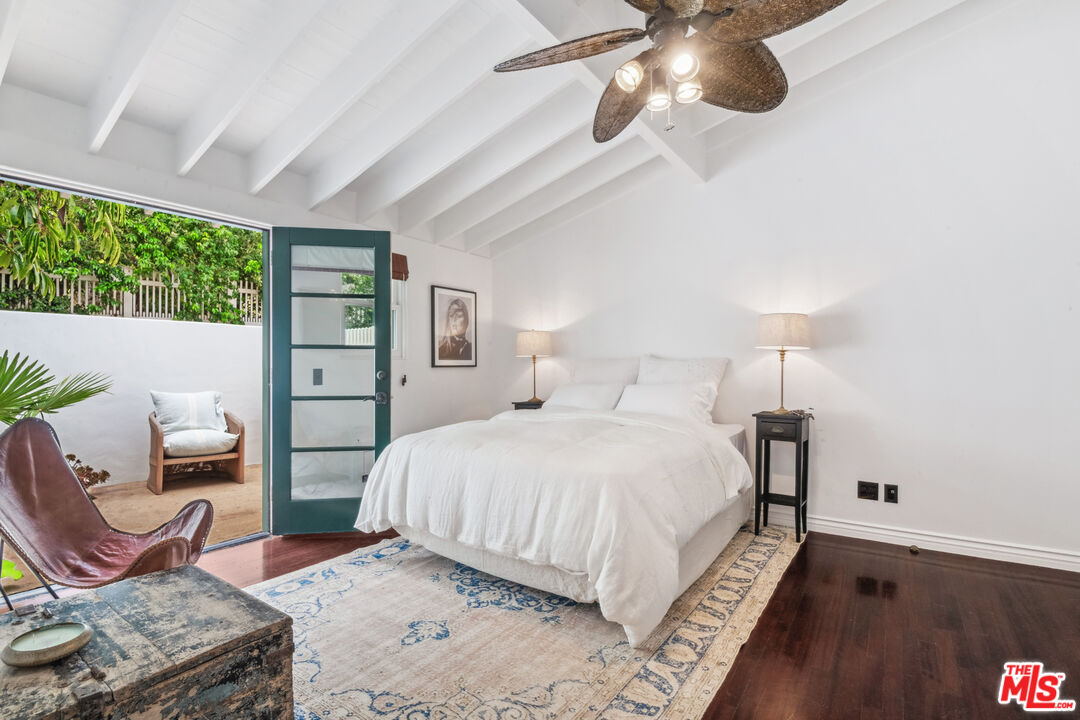 26799 Sea Vista Drive Malibu, CA 90265 - Photo 16 of 32 a bedroom with a bed and wooden floor