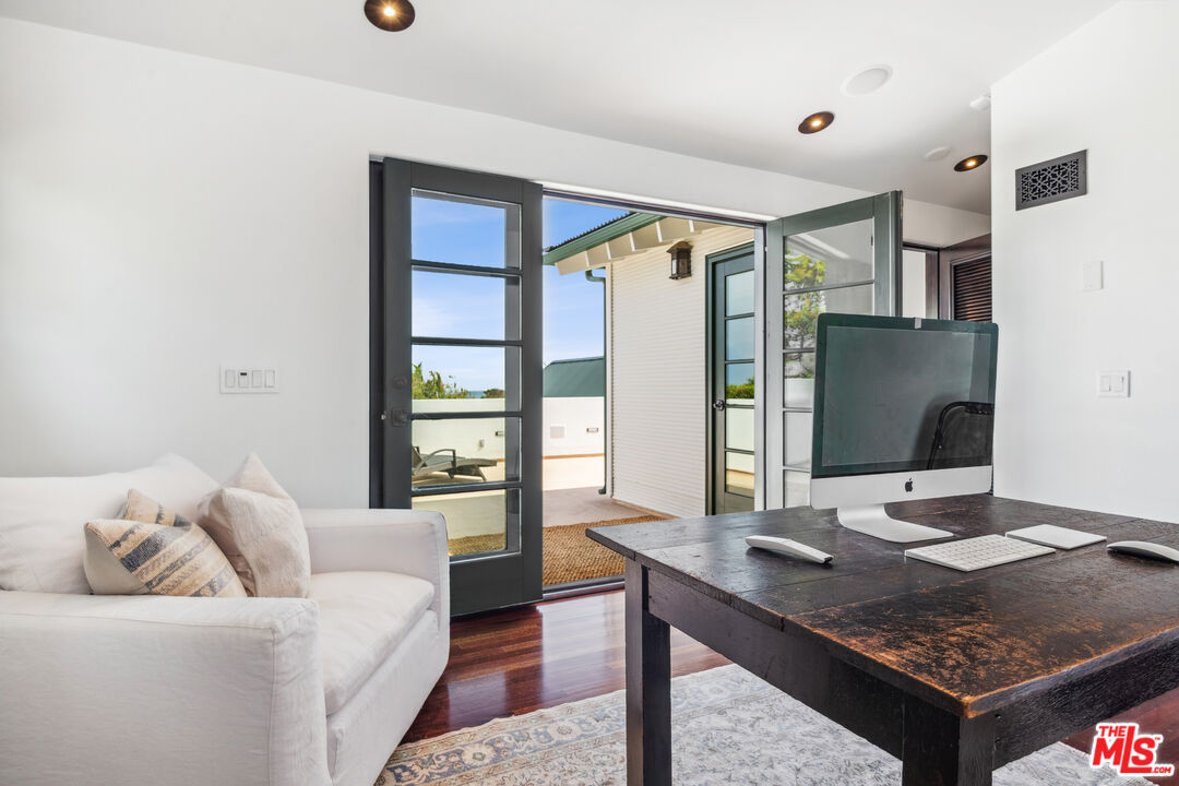 26799 Sea Vista Drive Malibu, CA 90265 - Photo 17 of 32 a living room with furniture rug and a flat screen tv