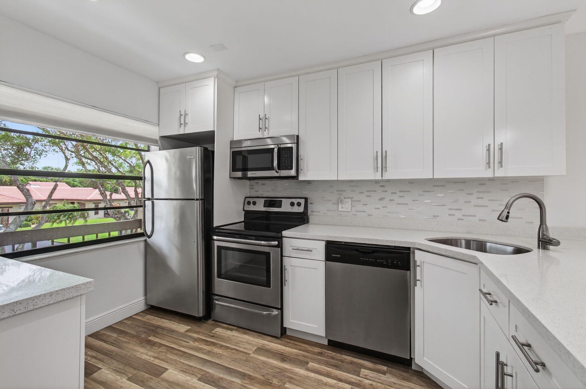 8536 Casa Del Lago, Unit 49B Boca Raton, FL 33433 - Photo 2 of 79 a kitchen with stainless steel appliances granite countertop a refrigerator sink and stove