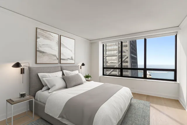 a bedroom with a large bed and a large window